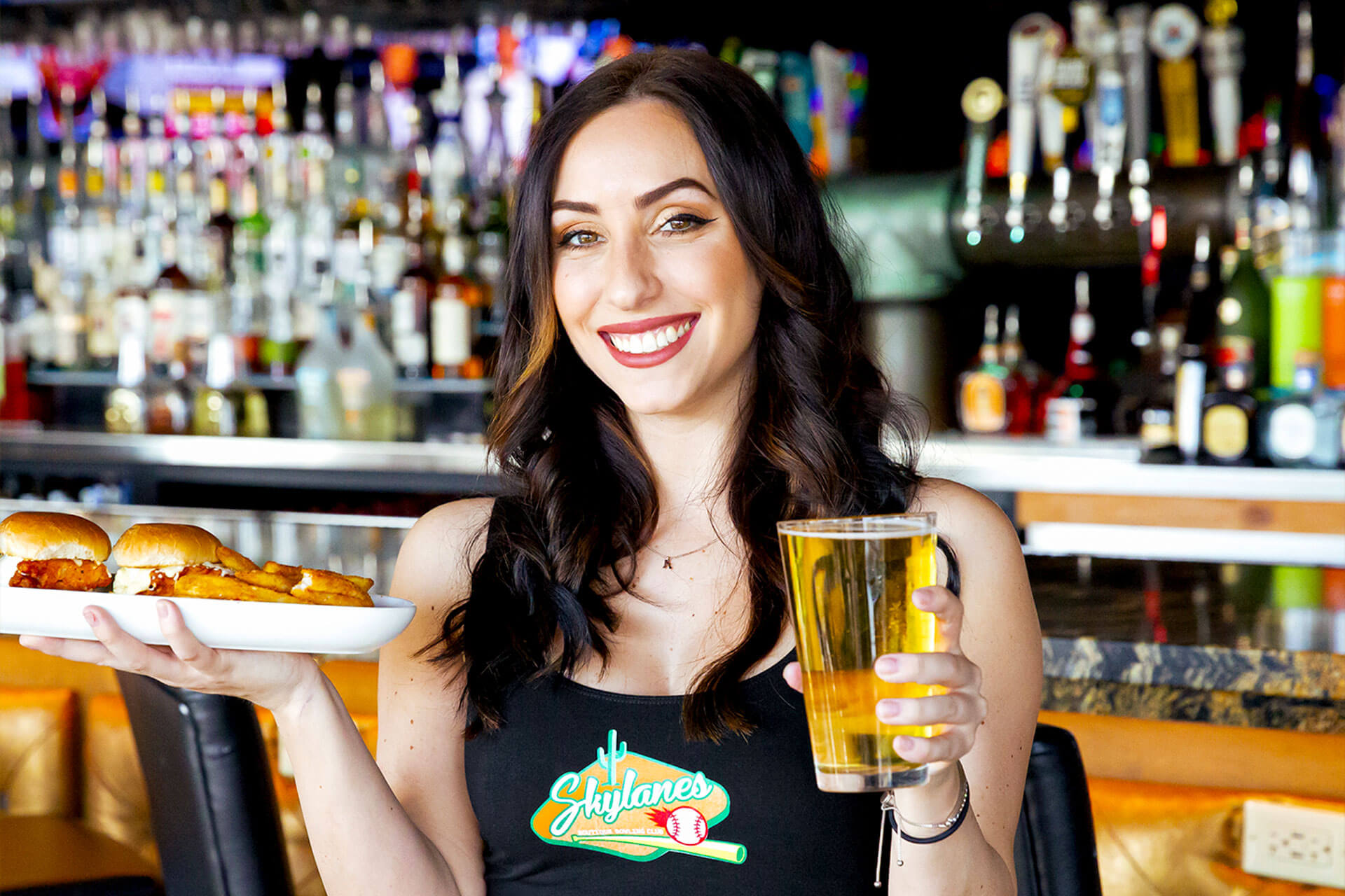 girl holding sliders and a beer